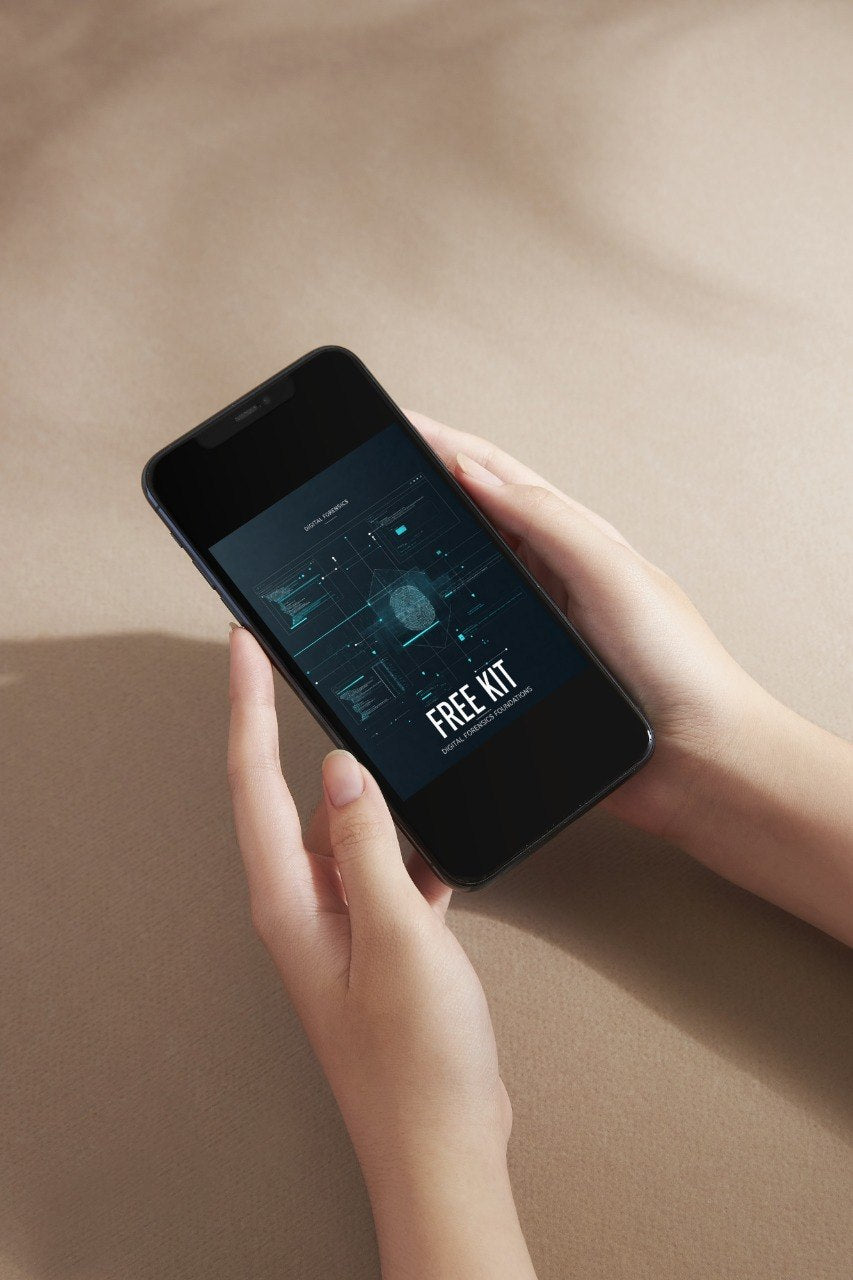 A person holds a black smartphone with both hands against a warm beige background. The phone screen displays a dark digital interface with the text 'FREE KIT'.